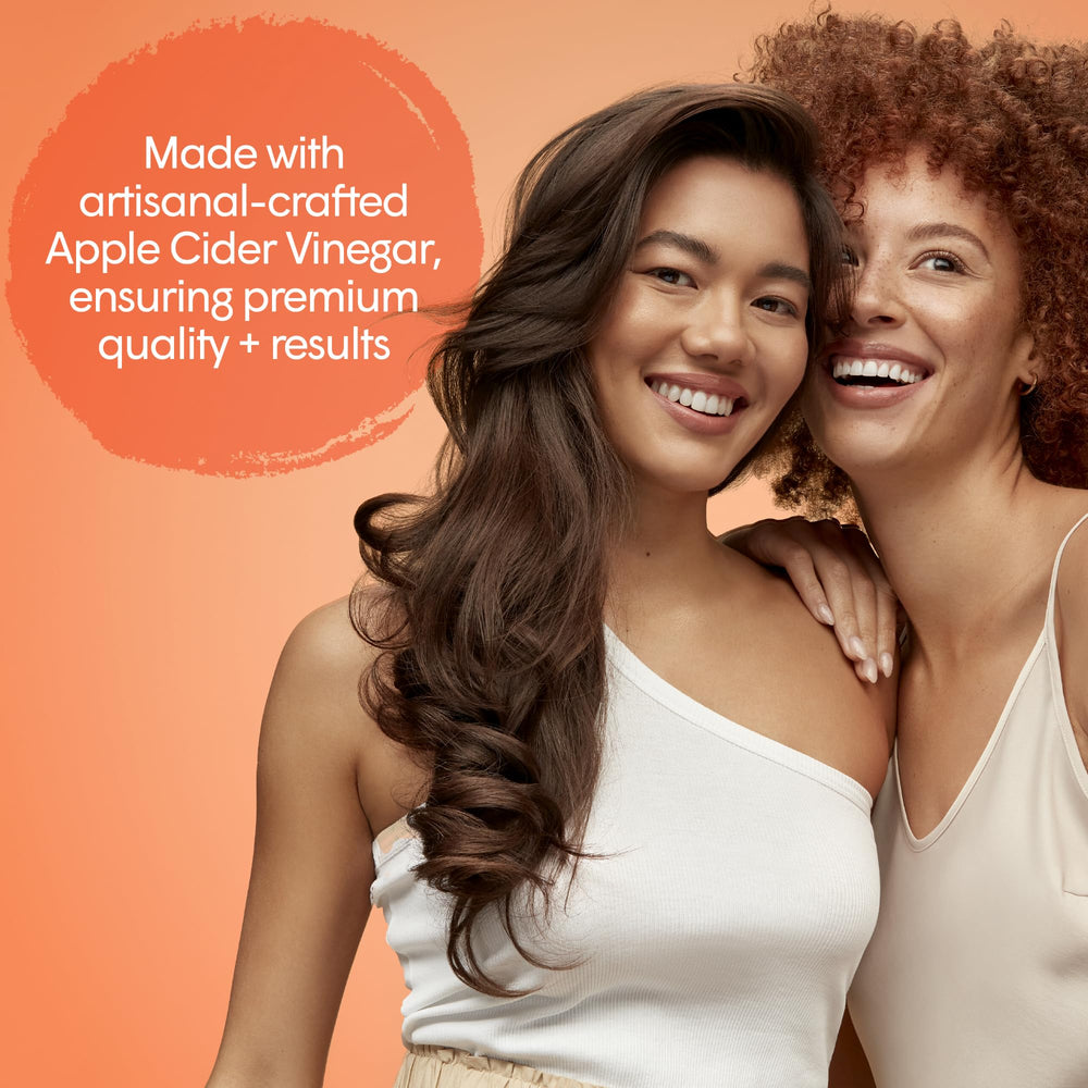 Hands applying dpHUE ACV Revitalizing Conditioner through damp hair for even distribution