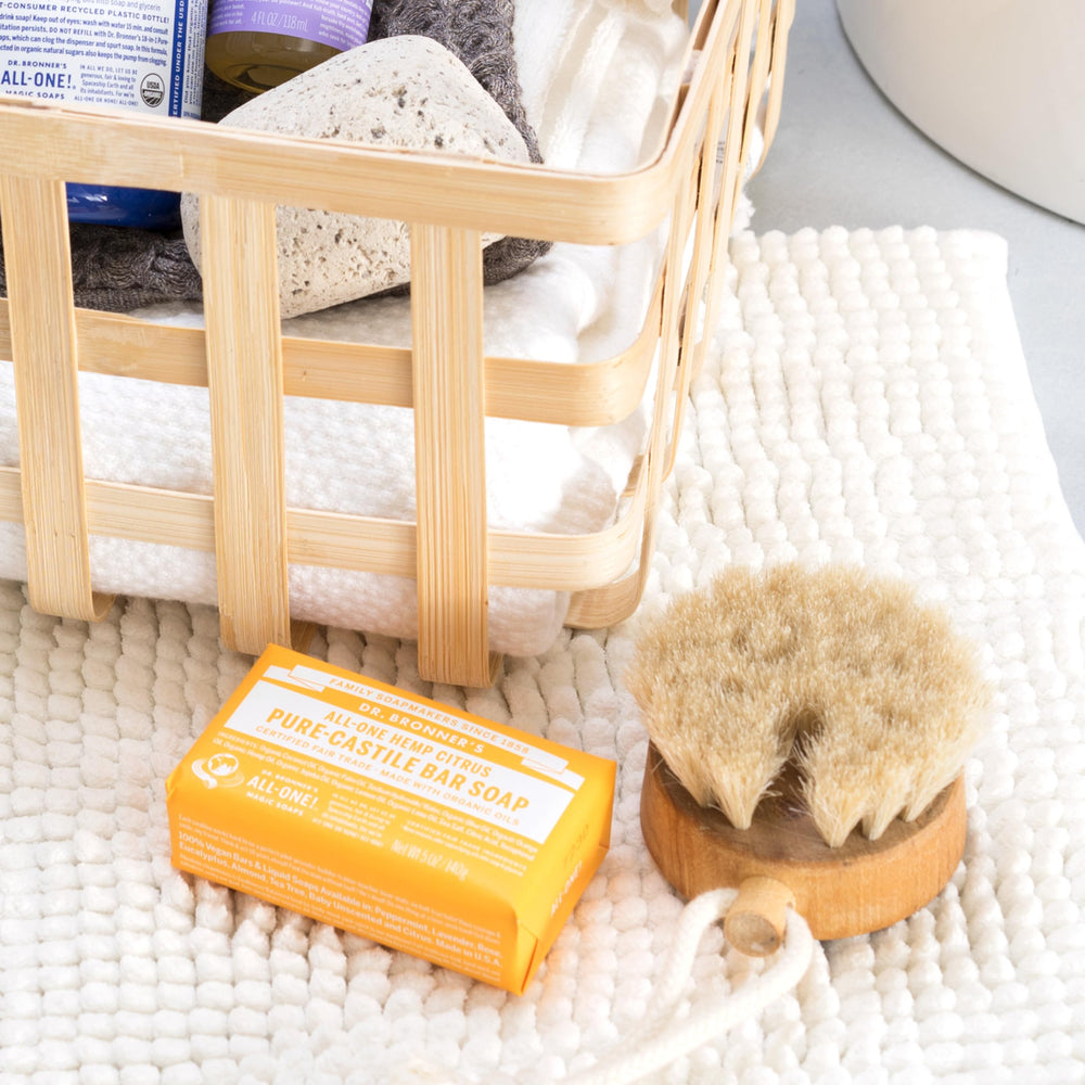 Lathering citrus bar soap in shower for body cleansing