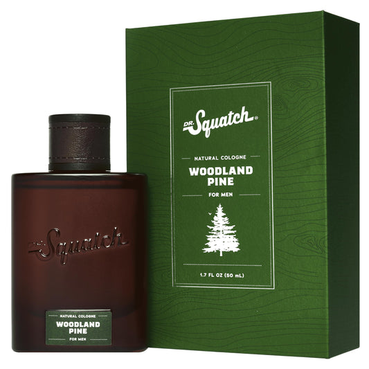 Dr. Squatch Woodland Pine Cologne bottle on wood for daily confidence and lasting scent.