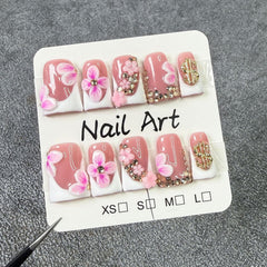 Closeup of gold rhinestones on Duckbill nails for a sparkling look