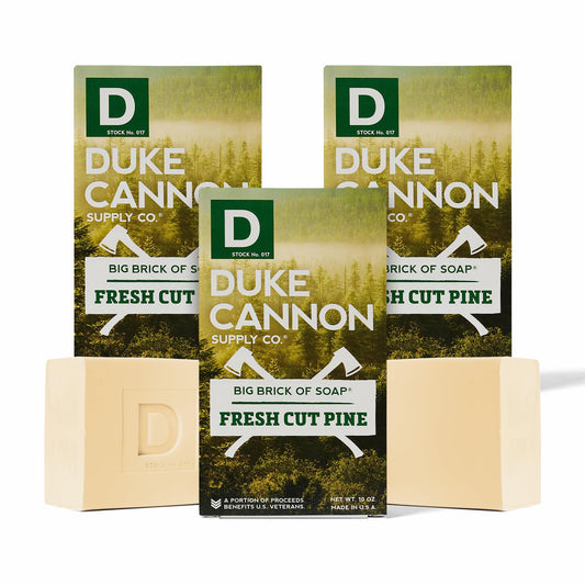 Duke Cannon big brick soap for men with fresh cut pine packaging on rugged surface.