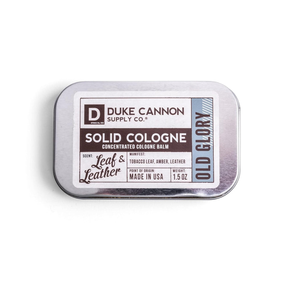 Duke Cannon Old Glory solid cologne tin front, portable fragrance for on-the-go refreshment.