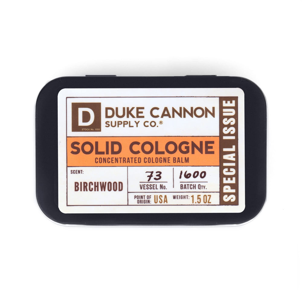 Duke Cannon Birchwood tin in leather briefcase demonstrates travel-friendly fragrance.