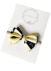 EdenBEbows nylon headband with bow in nude tone for versatile outfits.