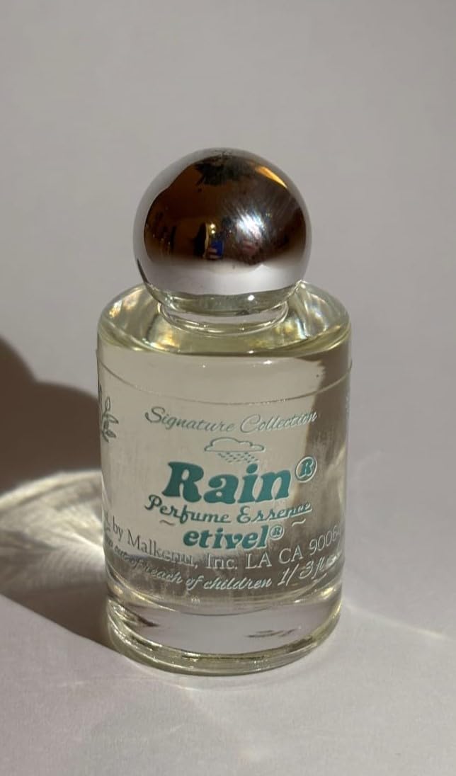 Etivel Rain perfume oil on skin for lasting freshness.