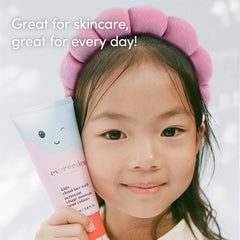 Evereden Kids Spa Headband keeps hair away from eyes during face washing.