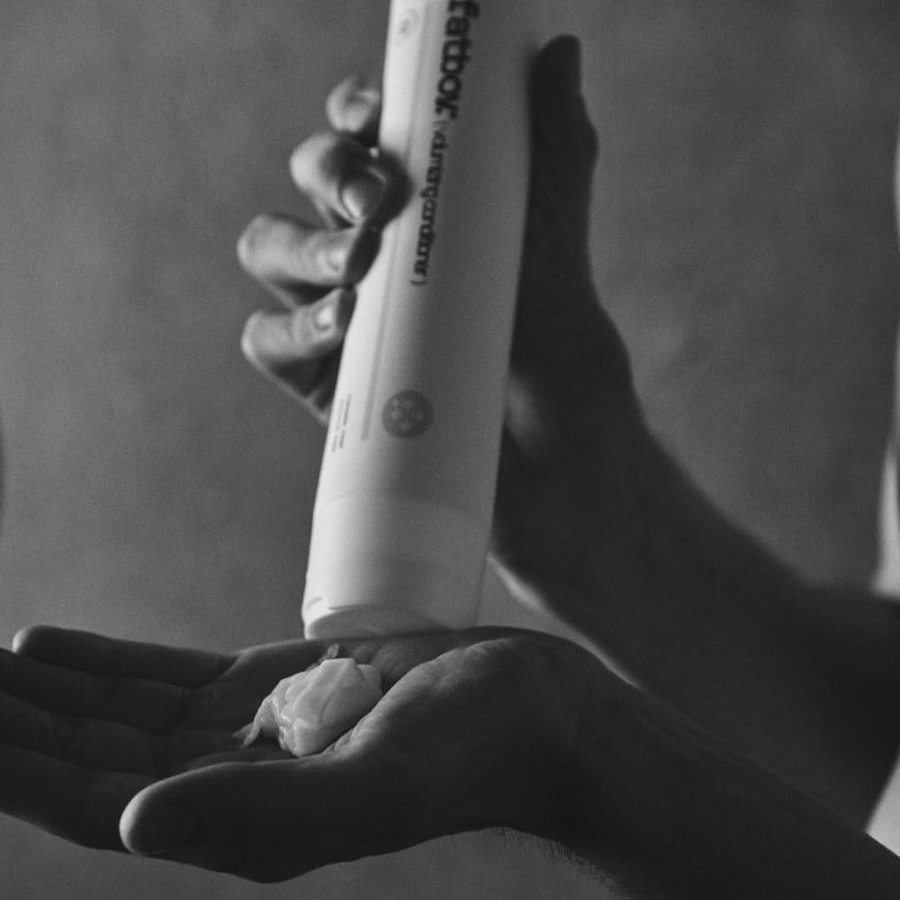 Cruelty-free Fatboy Moisturizing Shampoo arranged in a simple bathroom scene.
