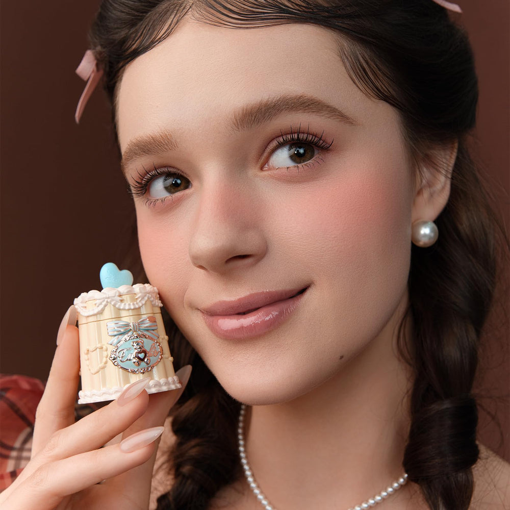 Dispense shot of Flower Knows Sweetie Bear Lip Jelly on fingertips