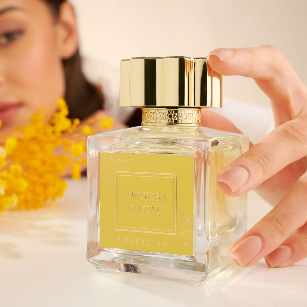 Flower Scents Mimosa Glow hand-holding pose signals personal fragrance ritual.