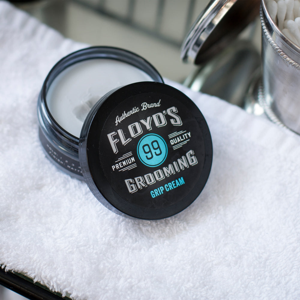 Applying Floyd's 99 Grooming Grip Cream through hair for defined shape.