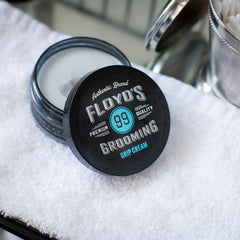 Applying Floyd's 99 Grooming Grip Cream through hair for defined shape.