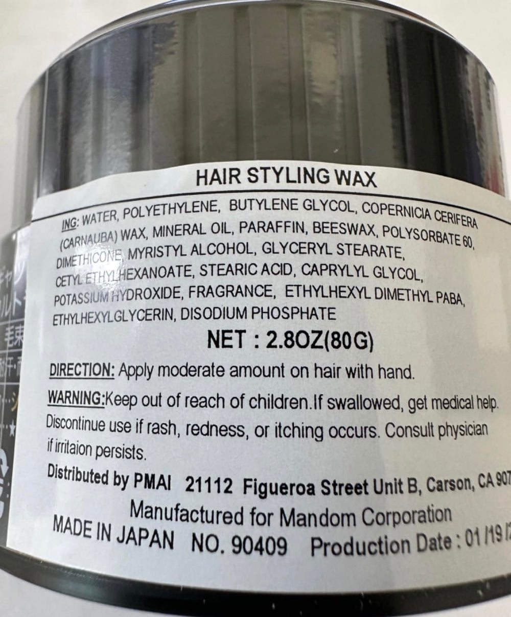Gatsby Styling Ultra Hard Type Wax in hand for precise shaping.