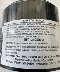 Gatsby Styling Ultra Hard Type Wax in hand for precise shaping.
