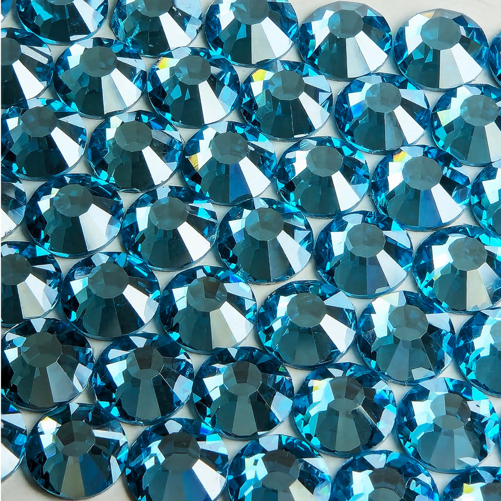 Genie Crystal Ice Aquamarine flatback crystals closeup showing translucent glow.