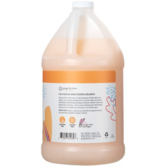 Pouring Coco Mango shampoo forming rich lather on wet hair