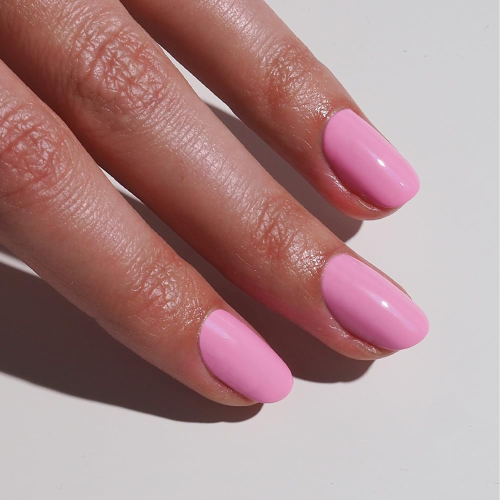gitti Solar Pink bottle with brush mid-stroke for precise color laydown.