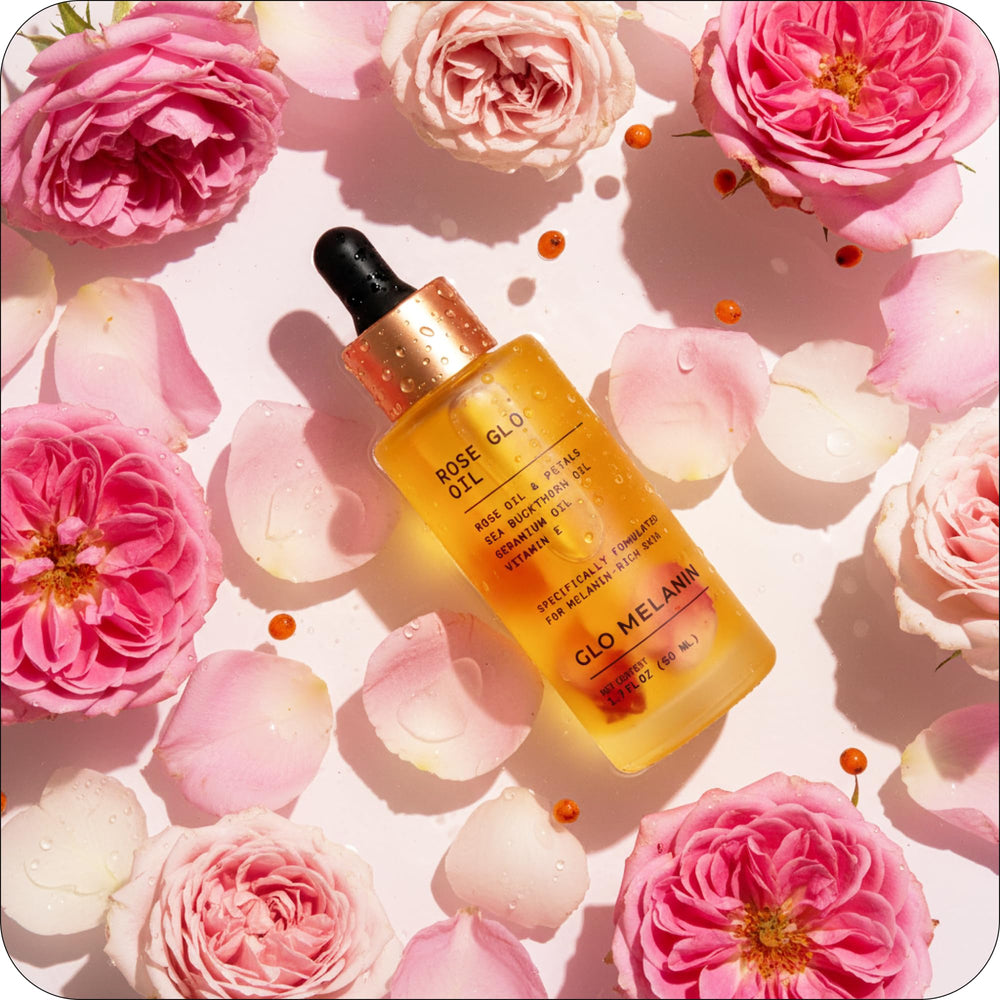 Glo Melanin Rose Glo Oil being applied to hands for moisture.