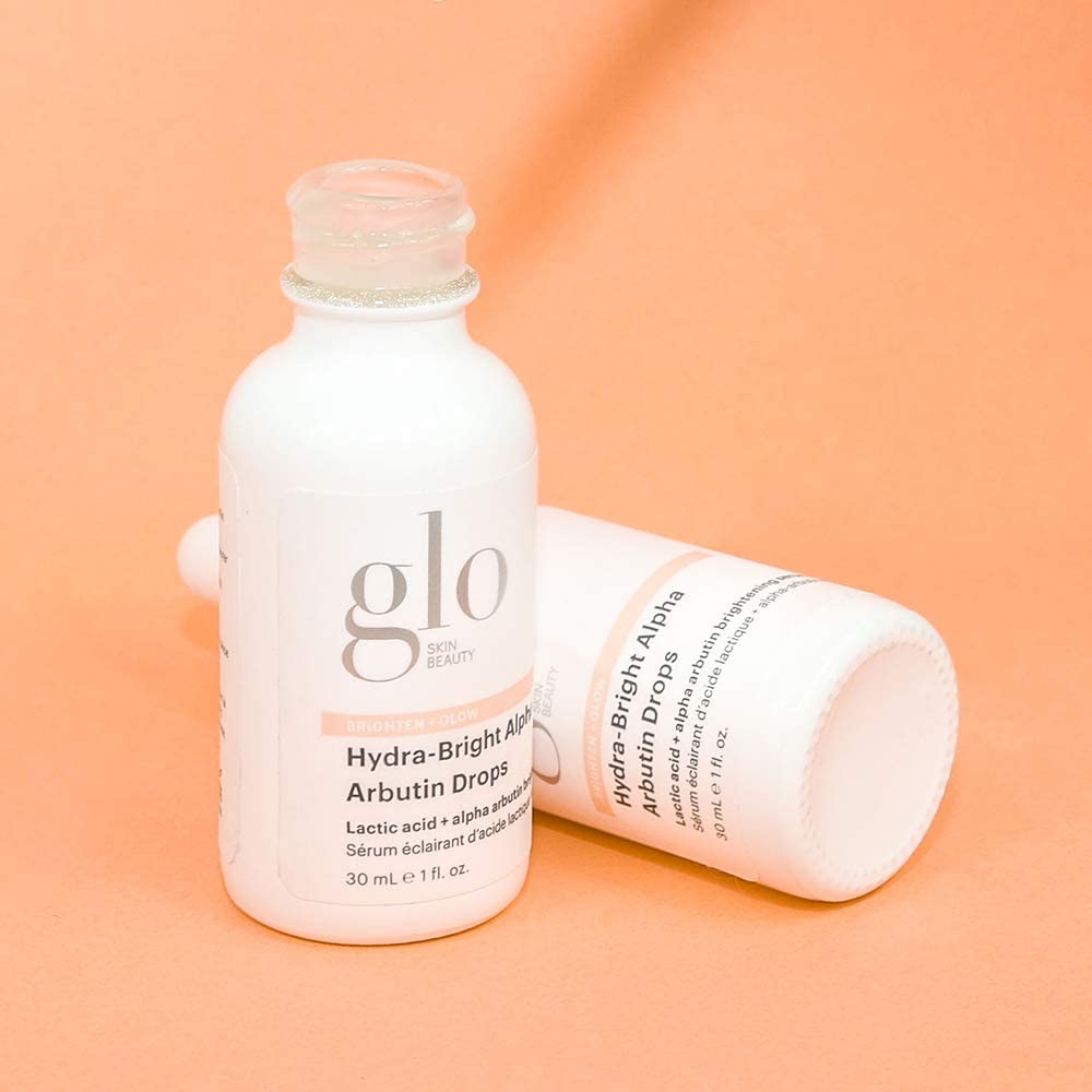 Glo Skin Beauty Hydra-Bright Alpha Arbutin Drops applied with dropper on clean skin.