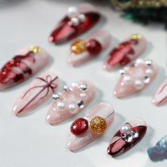 GLORS nails feature pearl embellishments and glitter for holiday glamour and sparkle.
