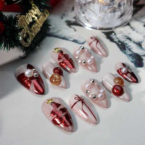 GLORS nails show red bow details with gold accents for party-ready shine.