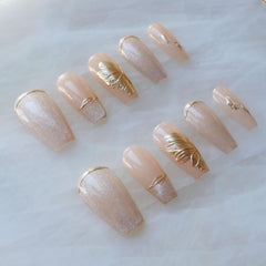 GLORS long ballerina nails in nude pink with gold accents for elegant evenings