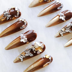 GLORS pearl embellishments on stiletto nails for elegant style