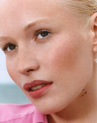 Glossier Cloud Paint Dune gel-cream texture gliding on skin for natural flush.