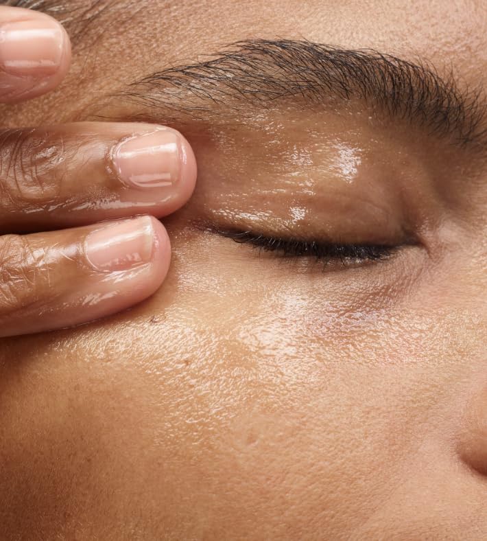 Close-up of Glossier Milky Oil formula dissolving waterproof makeup