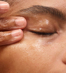 Close-up of Glossier Milky Oil formula dissolving waterproof makeup
