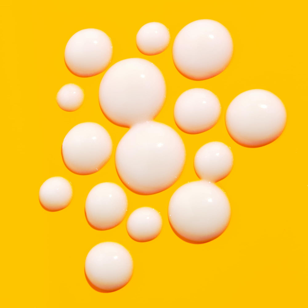 Good Molecules Vitamin C Serum with Oryzanol close-up on a smooth skin texture after application.
