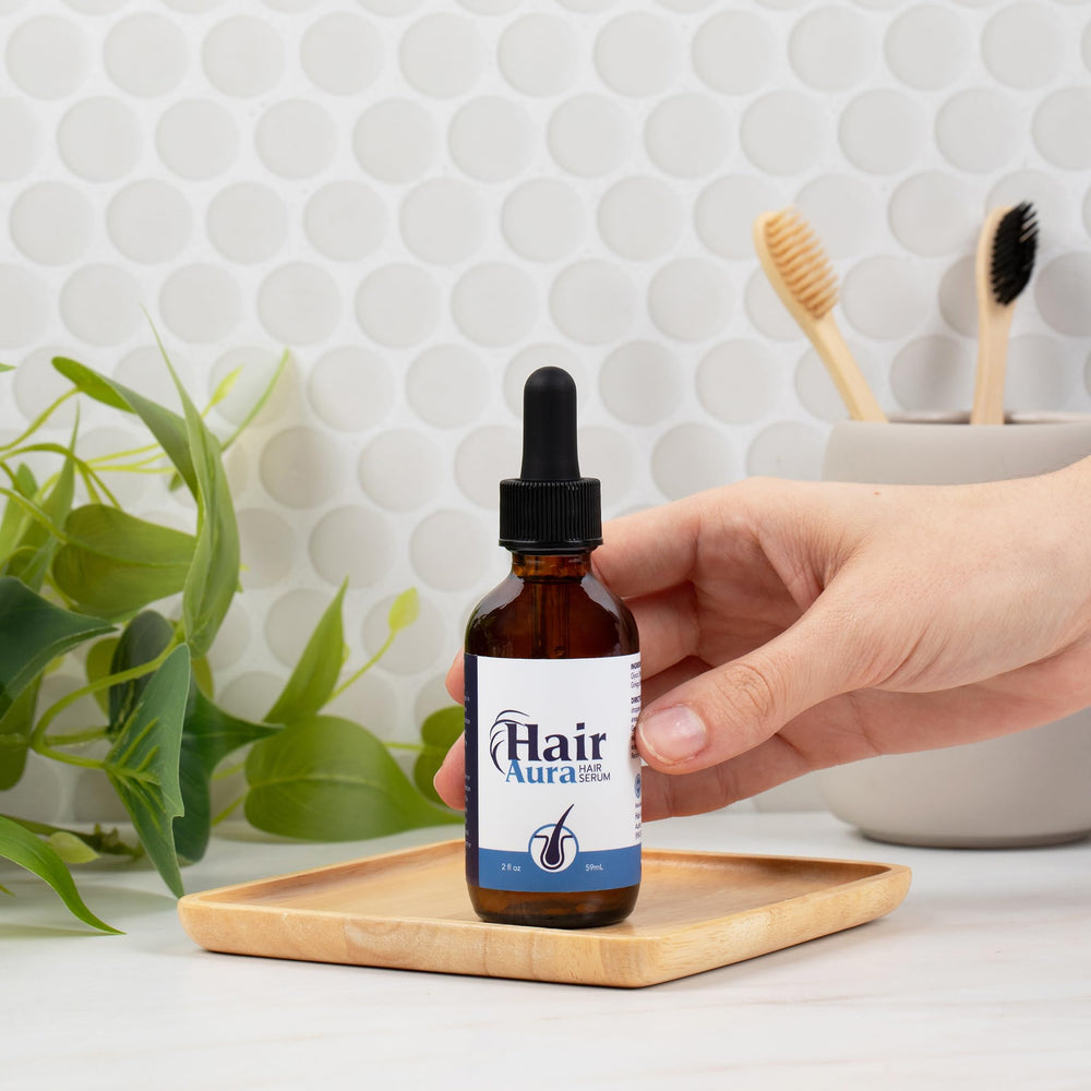 Hair Aura bottle on wood surface highlighting premium formulation.