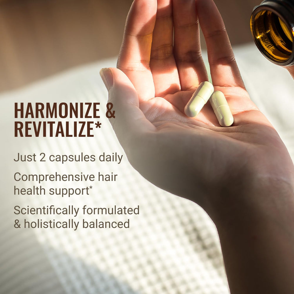 Hair La Vie Revitalizing Blend capsules resting on a clean surface.