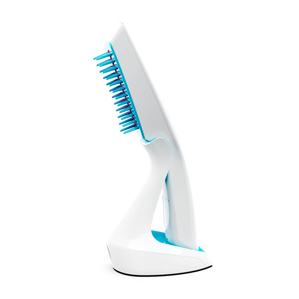 HairMax Ultima 12 Classic LaserComb on charging dock ready for routine treatments.
