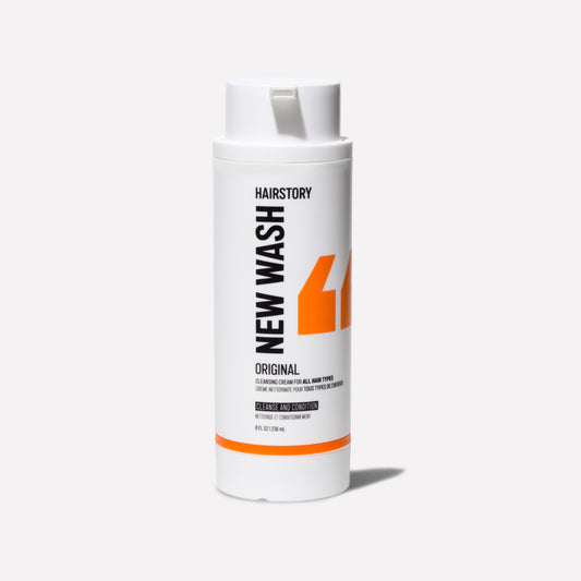 Hairstory New Wash Original refill bottle pour showing convenient, gentle cleansing.