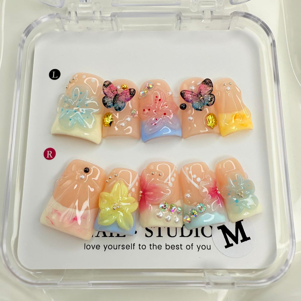 Butterfly design press-on nails for quick, elegant manicure.