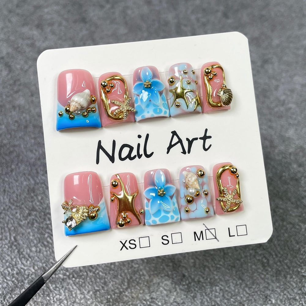 Handmade press-on nails featuring blue flower embossing for chic daytime wear.