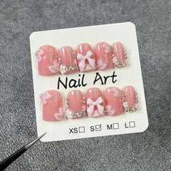 Handmade press-on nails featuring rhinestone design for a glamorous look.