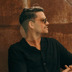 Close-up of hands applying Hardworking Gentlemen clay to hair