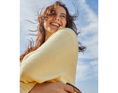 Hawaiian Tropic sunscreen in use during a hiking outdoor moment.