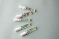 Wanderlust vial with patchouli and frangipani notes for adventurous moments.