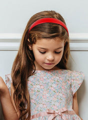 Durable plastic hard Huachi headband in red for daily use.