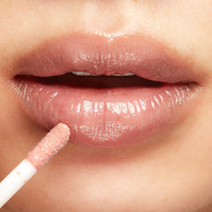 100% PURE Naked lip gloss mirror-like shine boosts lip radiance.