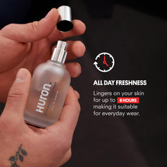 Lit glass bottle of Huron Men's Cologne evokes warm, inviting ambience