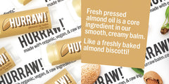 Hurraw Almond lip balm being applied for nourished, soft lips.