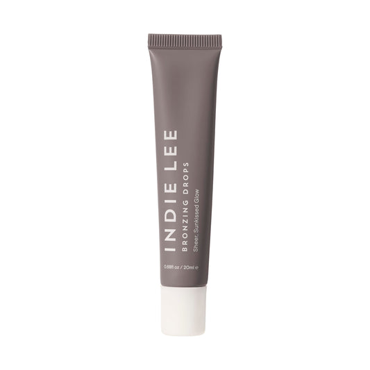 Indie Lee Bronzing Drops on face and body create a natural, hydrating glow.