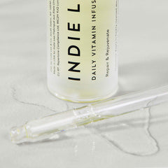Indie Lee Daily Vitamin Infusion packaging on display emphasizes clean skincare
