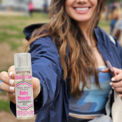 Infinix Baby Fresh Powder Mist compact bottle in a gym bag.