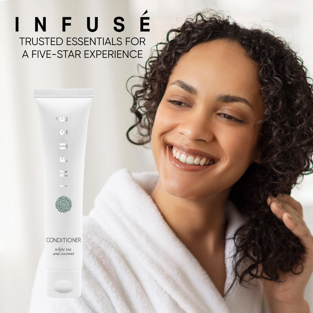 Aloe and olive oil-infused INFUSÉ conditioner bottle signaling premium amenities.