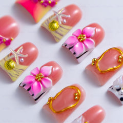 Intovibes nails with 3D flowers and shells for playful texture.
