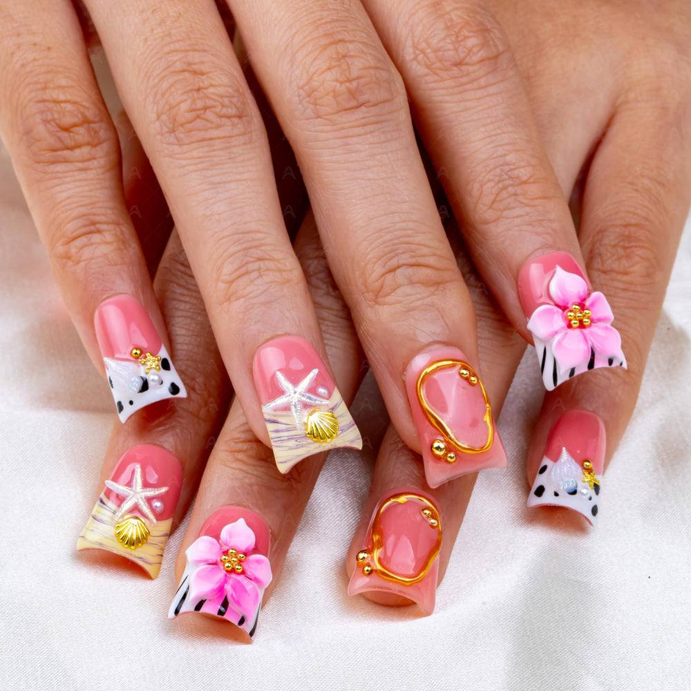 Intovibes nails featuring conch shells and starfish accents for festive looks.
